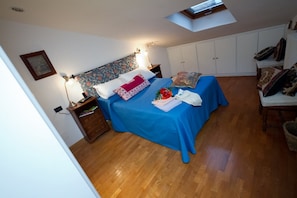The bedroom is large and comfortable for two, with local textiles and linens.
