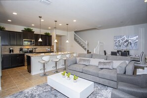 Bright and airy living space with plush seating and a Smart TV for family movie nights.