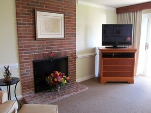 A wood burning fireplace can be enjoyed in the living, dining and kitchen area.