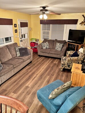 Living Room with sleeper sofa, loveseat and two chairs. Great view of the lake!