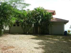 Front of the house with grown trees 