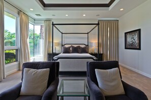 Master Bedroom with seating area and a 70" HDTV.