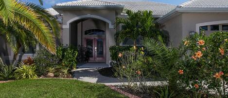 Lovely front entrance with lush gardens