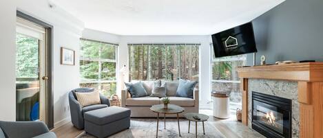Living area: Pull-out sofa, forest view, balcony access