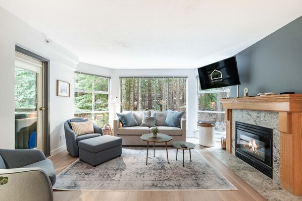 Living area: Pull-out sofa, forest view, balcony access