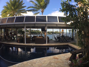 Bayview deck on main level w/ lounge and dining area adjacent to salt water pool
