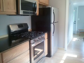 Gas oven and a stocked pantry with essentials. 