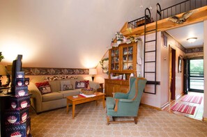 Living Room, Television, and Barn-Style Iron Ladder to the Loft.