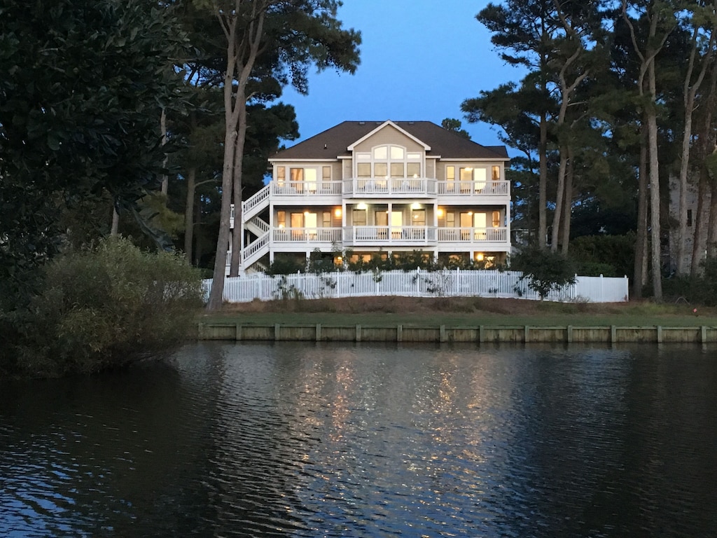 large house in front of a body of water