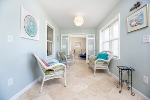 Unique Sunroom with gorgeous Custom Tile and Wicker Furniture welcomes you.