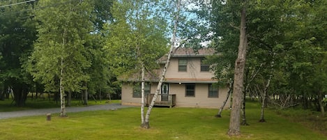 Summer day- House is surrounded by trees