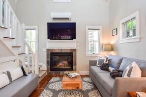 The living room with stairs leading to the loft bedroom.