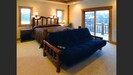 master bedroom suite with California King log bed and wheelchair access shower