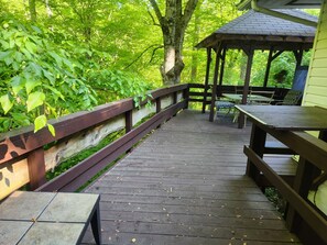Large deck with gazebo dining/lounging area, like being up in a treehouse.
