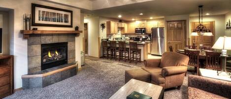 Main living area highlighting fireplace, large kitchen and large dining.