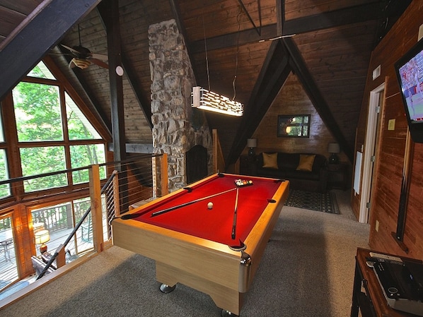 Living/pool table room with unobstructed view thru front windows to Mt Leconte!