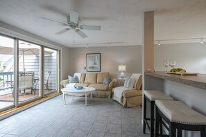 Kitchen bar and living room with view of the pond and fountains.