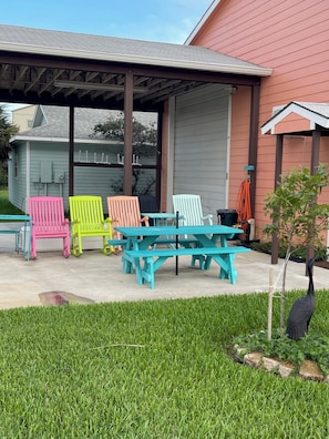 Rock on.  Propane grill and Old Smokey grill under carport. Picnic table to dine