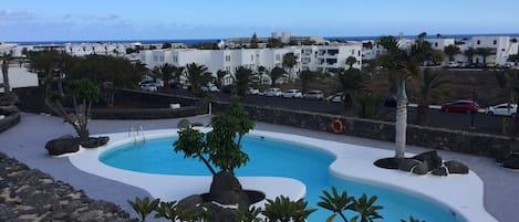 Pool view from terrace with sea views in the horizon 
