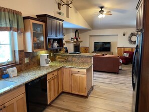 The fully stocked upstairs kitchen is open to living and dining areas