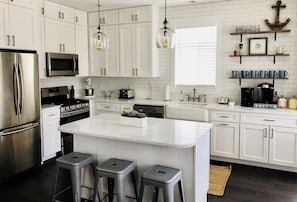 Fully equipped, brand new kitchen. The Island is a great space to gather!