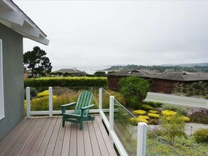 Relax on the balcony chairs and watch the ocean waves crash against the rocks.