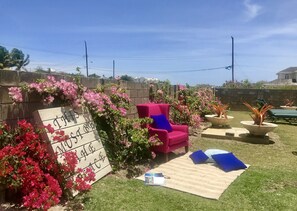 Garden area with sun loungers, dining and BBQ grill