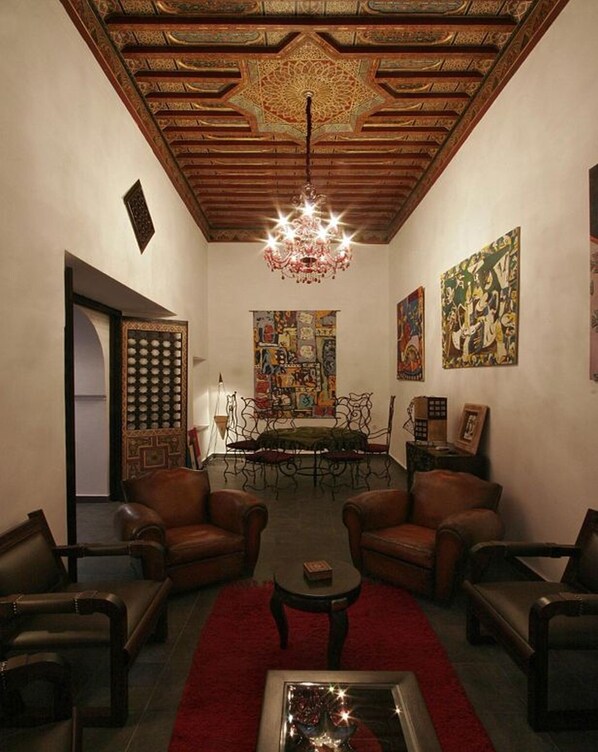 Main lounge of house with ancient 200 year ceiling, modern art and furniture