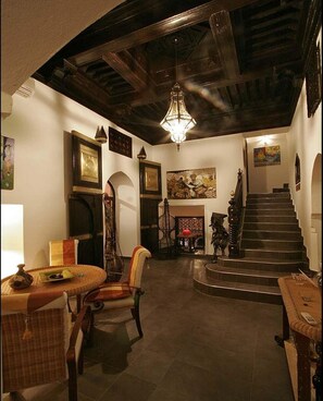 Hallway with antique doors, cedar ceiling and contemporary African art pieces