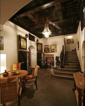 Hallway with antique doors, cedar ceiling and contemporary African art pieces