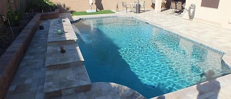 Swimming pool/deck area.  Note:
Artificial turf patch w/ large umbrella.