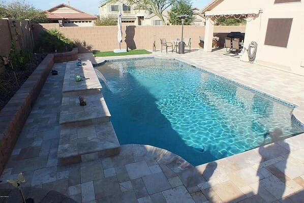 Swimming pool/deck area.  Note:
Artificial turf patch w/ large umbrella.
