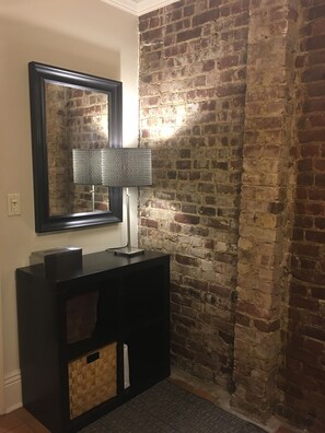 Master Bedroom w exposed brick wall