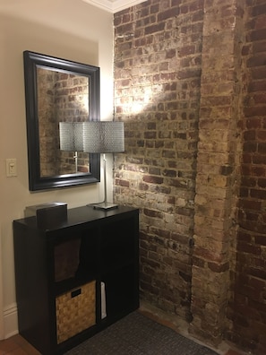 Master Bedroom w exposed brick wall