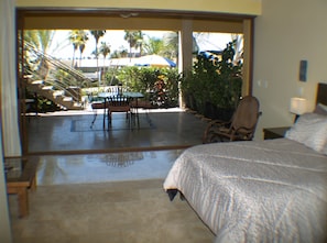 Studio suite looking out to dining area,pool, and views of golf course and ocean