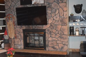 Large common area TV above fireplace with a lovely coffee station
