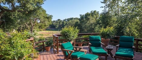 Redwood deck with view of back meadow and More Mesa beyond. 