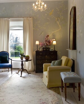 The birdroom has handpainted walls of birds in a Chinoiserie style 