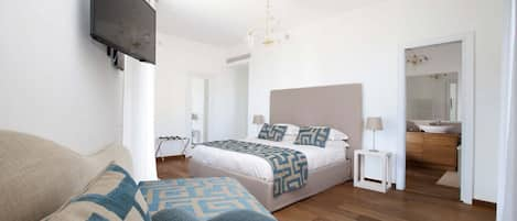 Bedroom 1: King Bed with handmade matress with memory foam and Fresh Linens, 1 Single Bed, En-suite bathroom, Balcony with table and chairs, Murano Chandelier, access to balcony with sea view, 32″ Flat Screen TV, Walk in Wardrobe Space, AC