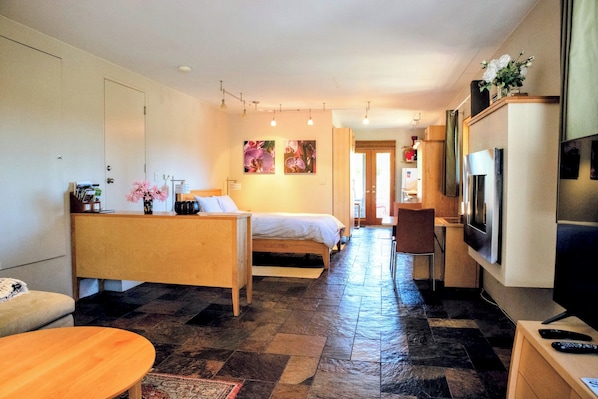 Bedroom area with dining table that opens up to sit six