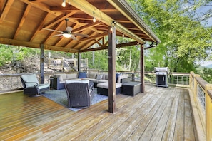Large Covered deck with hot tub, weather blinds, grill, and long range views