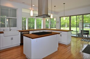 The kitchen - farm sink, gas cooktop, lots of cherry butcherblock countertops
