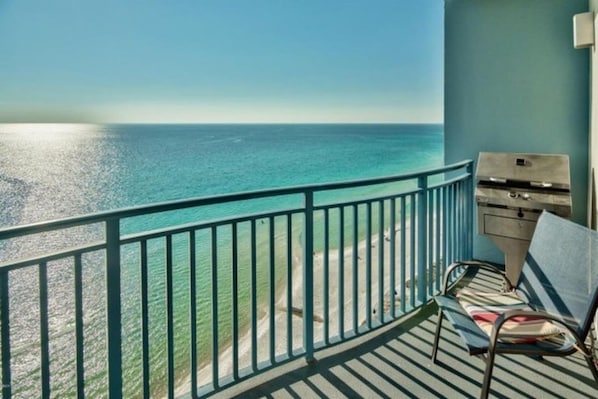 Sunset view of beach from balcony - Enjoy grilling fresh seafood on the patio!