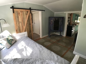 The sitting room with daybeds, custom stencil floor and sliding barn door 