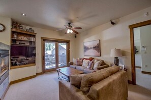 Cozy up with. your favorite show by the fire in the comfortable seating area.