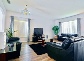 Family room with leather seating and multi-channel Cable TV and DVD player