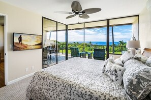 Primary Bedroom with King Bed, TV, and Access to the Lanai at Country Club Villas 318