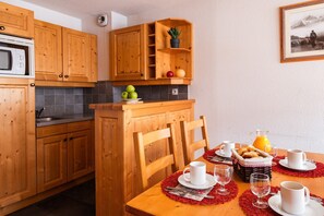Prepare meals in the kitchenette and enjoy them at the dining table.