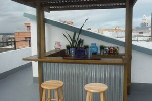 Equipped Tiki Bar, sink, BBQ gas grill and lots of prep area on the terrace. 