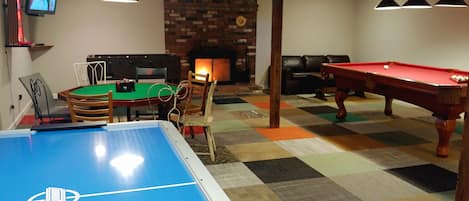 game room: flatscreen TV, fireplace, foosball, pool, poker, airhockey, boss toss